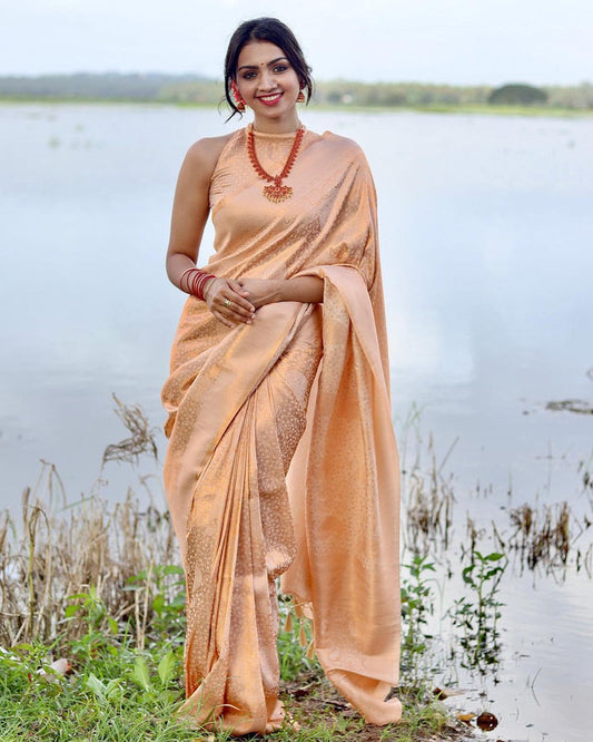 PHENOMENAL LIGHT ORANGE SOFT BANARASI SILK SAREE WITH IMBRICATION BLOUSE PIECE